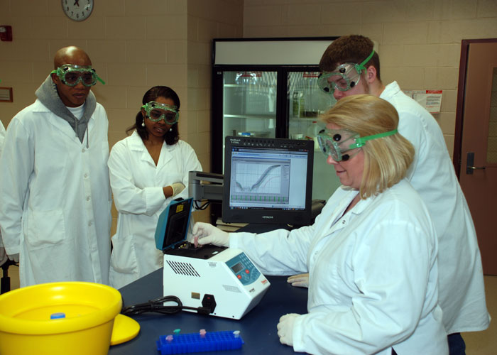 Students in protective clothing separating fluids