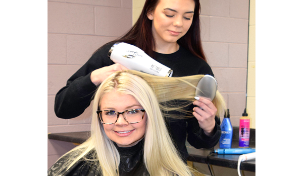 Student doing a blow-dry