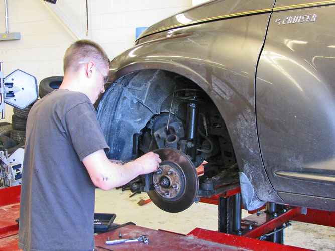 student working on brakes