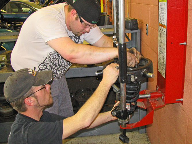 Students working spring compressor
