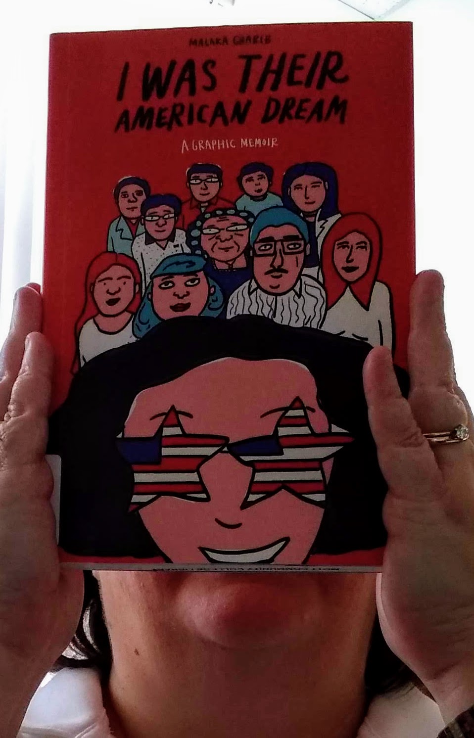 Jill covering face with face on a book