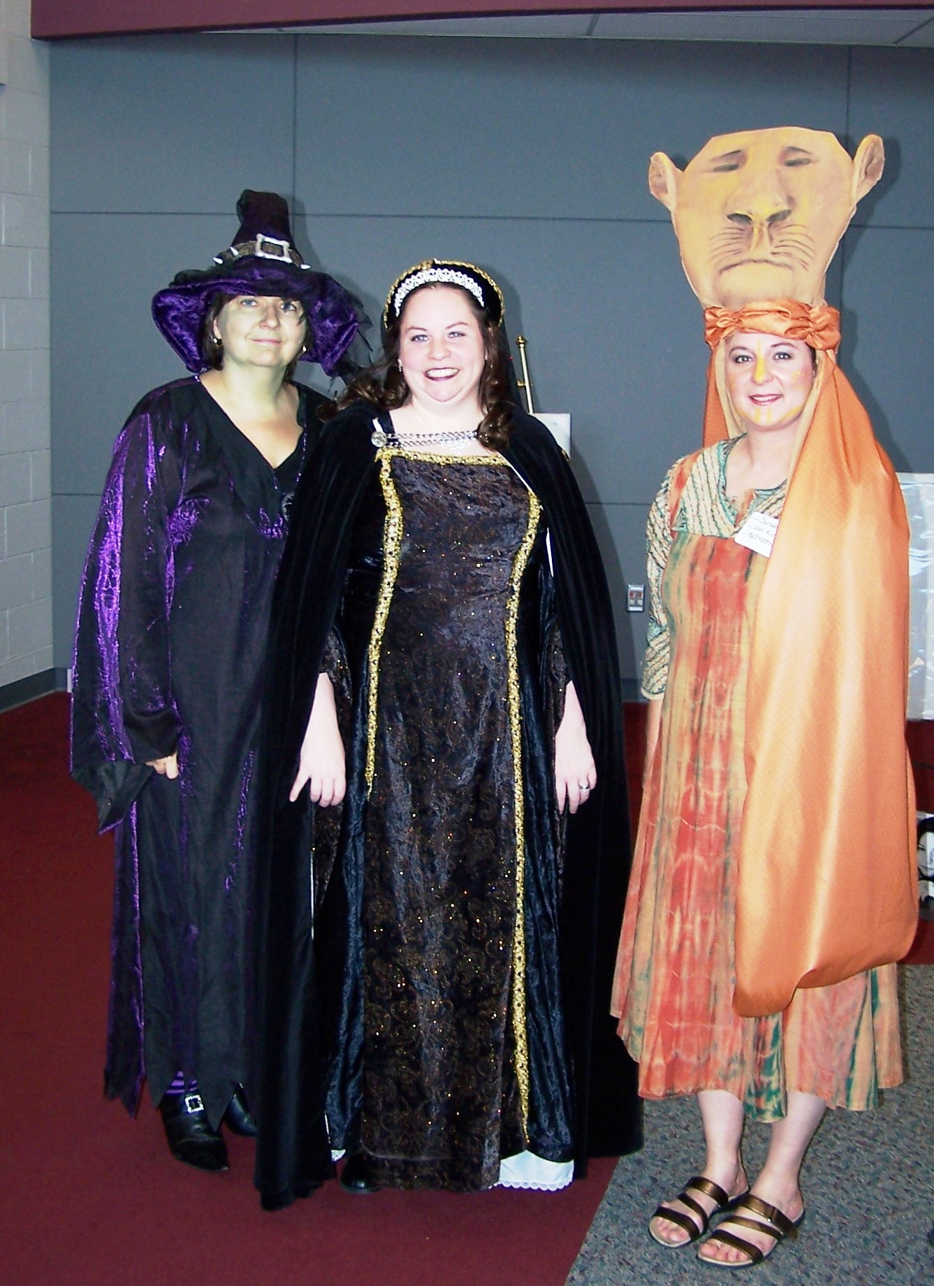 Librians dressing up as favorite book characters - wicked witch, camelot queen and lion