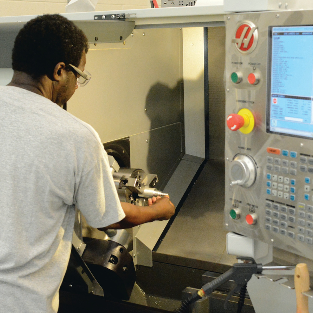 student running a CNC machine
