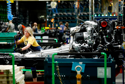 Female working on automotive assembly line